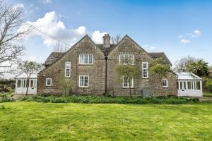 an old brick house with a large yard at South Cottage in Sherborne