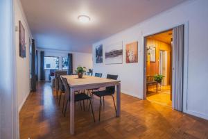 a dining room with a table and chairs at NORD Apartment in Tromsø +11 photos
