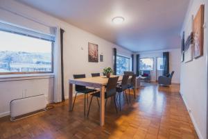 a dining room with a table and chairs at NORD Apartment in Tromsø