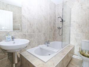 a bathroom with a sink and a shower and a toilet at Snowdonia View in Pwllheli +36 photos