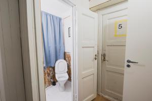 a bathroom with a toilet and a door at NORD Apartment in Tromsø