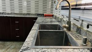 a kitchen with a sink and a counter top at Prime Ville in Rubuchi +22 photos
