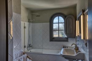 a bathroom with a tub and a sink and a window at Les Hamaques hotel in Viladamat +45 photos