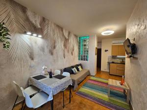 a living room with a table and a couch at Appartamento Rosa Calabria in Roseto Capo Spulico
