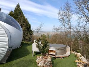 an rv sitting on the grass next to a yard at Les Bulles du Coq de Champagne in Dormans