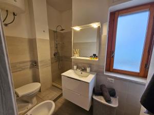 a bathroom with a sink and a toilet and a shower at Appartamento Rosa Calabria in Roseto Capo Spulico +15 photos