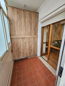 a room with wooden doors and a tile floor at Appartamento Rosa Calabria in Roseto Capo Spulico