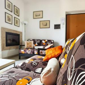 a living room with a couch with pillows on it at Casa Tonino in Pisticci +34 photos