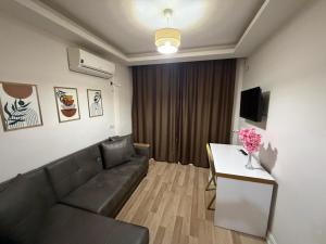 a living room with a couch and a table at Nativo Otel in Antalya