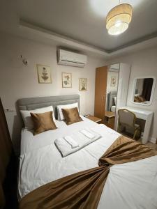 a bedroom with a white bed with two towels on it at Nativo Otel in Antalya