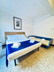 a bedroom with a large bed with blue sheets at Gest Short Rent Siena 3 in Siena