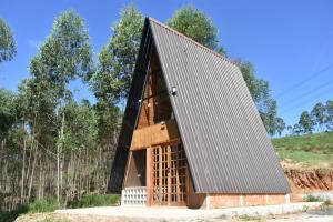 a tiny house with a black roof at Be Happy Park Piracaia in Piracaia