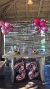 a table with a number two and balloons at Tamikuã Mar Pousada in Caraíva +69 photos