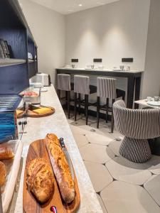a room with a table with some bread on it at Eiffel Yard Hotel in Paris