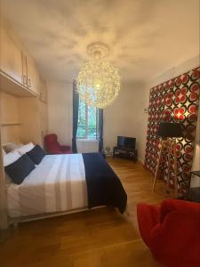 a bedroom with a large bed and a chandelier at Appartement François 1er in Vichy
