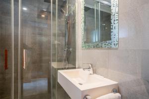 a bathroom with a sink and a glass shower at Hotel Costa Azahar in Grao de Castellón