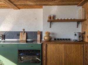 a kitchen with a sink and a counter top at Nido sull`Aqua Chalet with Whirlpool in Sigriswil +14 photos