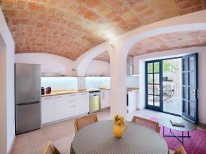 a kitchen with a table with a vase on it at Apartment at Cadaqués Church in Cadaqués