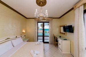 a bedroom with a bed and a desk and a television at DIO DEL MARE LUXURY ROOM in Porto Cesareo +42 photos
