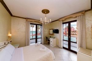 a bedroom with a large bed and a balcony at DIO DEL MARE LUXURY ROOM in Porto Cesareo