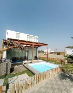 a villa with a swimming pool and a house at Casa Chincha in San Pablo