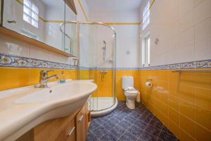 a bathroom with a sink and a shower and a toilet at Davina House - Terrace & Garden - Sea Views in St. Paul's Bay +27 photos