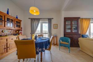 a kitchen with a table and chairs in a room at Davina House - Terrace & Garden - Sea Views in St. Paul's Bay