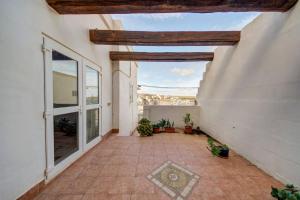 an empty courtyard of a white building with plants at Davina House - Terrace & Garden - Sea Views in St. Paul's Bay