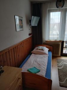 a bedroom with two beds and a table and a window at Na Brzysku in Jabłonka