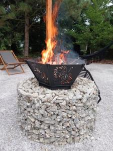 a fire pit in a large pile of rocks at Na Brzysku in Jabłonka