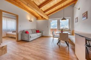 a living room with a couch and a table at Garni Schmiedhof in Naturno