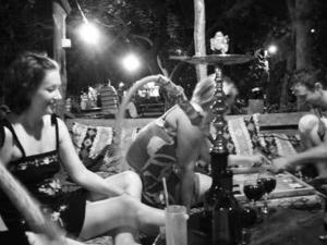 a black and white photo of people sitting at a table at Bayrams Tree Houses in Olympos