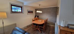 a small room with a table and a couch at Cherry Tree Cottage in Glencoe +9 photos