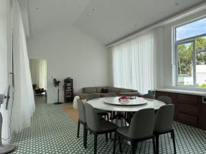 a living room with a table and chairs at Phong Tom Retreat - Pet friendly location in Long Khanh