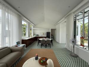 a living room with a couch and a table at Phong Tom Retreat - Pet friendly location in Long Khanh