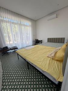 a bedroom with a large bed in a room at Phong Tom Retreat - Pet friendly location in Long Khanh