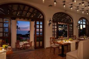 a dining room with a table and a view of the ocean at Elegant Beachfront Penthouse | Casa Del Mar Delfin in San José del Cabo