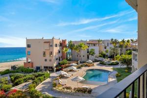 an aerial view of a resort with a swimming pool and the beach at Elegant Beachfront Penthouse | Casa Del Mar Delfin in San José del Cabo