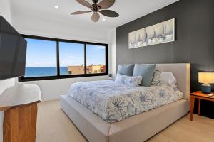a bedroom with a bed with a view of the ocean at Elegant Beachfront Penthouse | Casa Del Mar Delfin in San José del Cabo +43 photos