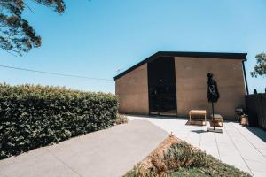 a building with a chair in front of it at Daybreak Loft. Willunga in Willunga