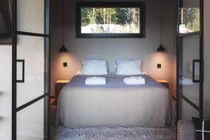 a bedroom with a bed with two towels on it at Stay North - Kajastus in Salo