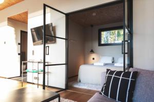 a bedroom with a bed and a mirror at Stay North - Kajastus in Salo