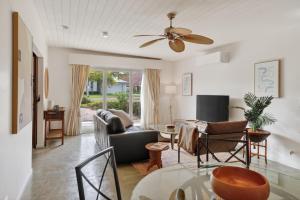 a living room with a ceiling fan and a table at Forty at Yellow Doors in Goolwa South