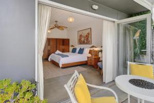 a bedroom with a bed and a table and chairs at Forty at Yellow Doors in Goolwa South