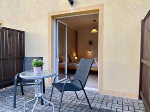 a patio with a table and chairs and a bedroom at Penzion Žírovice in Františkovy Lázně
