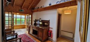 a living room with a fireplace in a house at Holly Tree Cottage in Glencoe