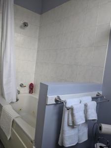 a bathroom with a bath tub with towels on it at Downtown Apt 2 executive 21 Queens Road in St. John's