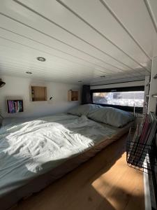 a large bed in the middle of a room at Tiny House Spreemaus in Hangelsberg