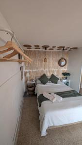 a bedroom with two beds and a ceiling at Tutto Passa Lloret in Lloret de Mar
