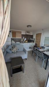 a living room with a couch and a table at Tutto Passa Lloret in Lloret de Mar +10 photos